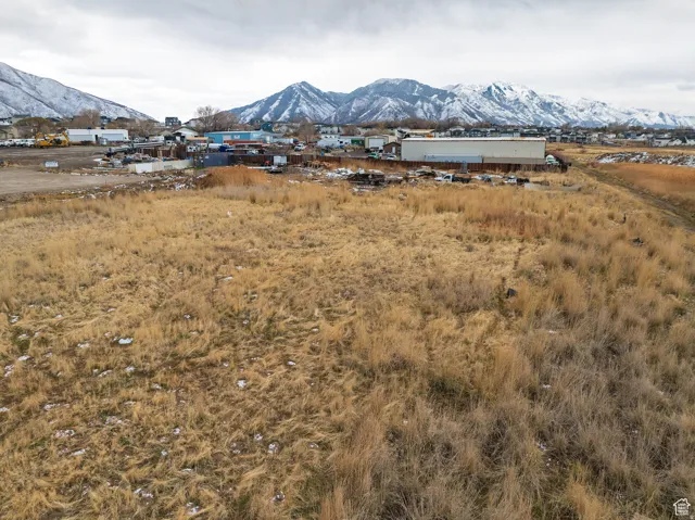 Expansive open land with distant snow-capped mountains
