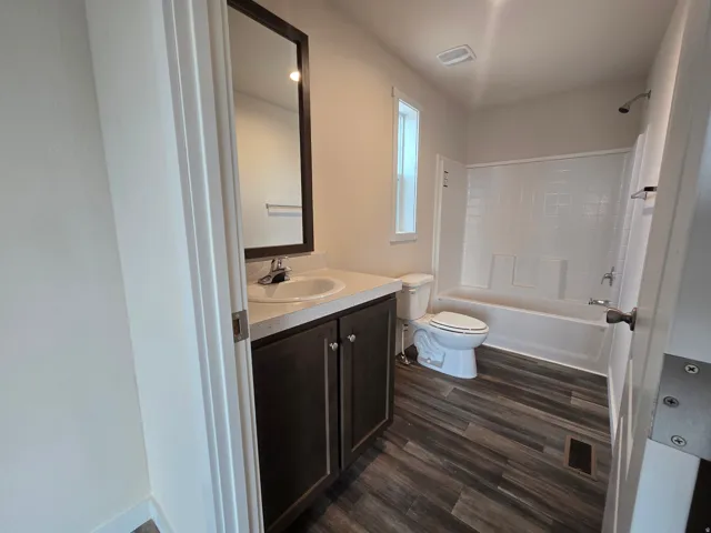 Master BathroomVanity with integrated sink, dark wood-finish cabinetry, and framed mirror. Tub Shower Combo