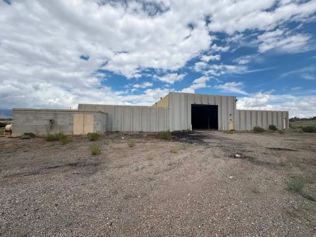 Industrial building with a large overhead door, block construction, and metal panel siding