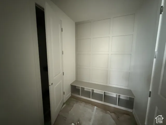 Built-in wall bench featuring partitioned storage cubbies and decorative grid wall paneling