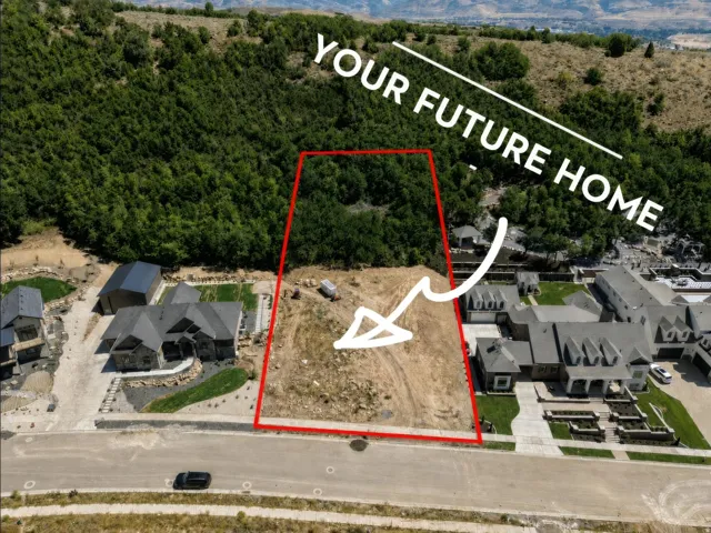 Real Estate Marketing Image. Aerial view of a vacant lot outlined in red, indicating the property for potential construction