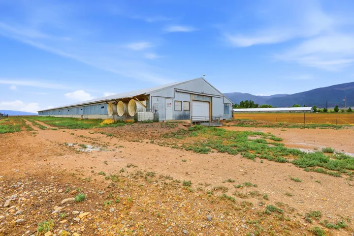 Large agricultural structure with metal siding and a gable roof