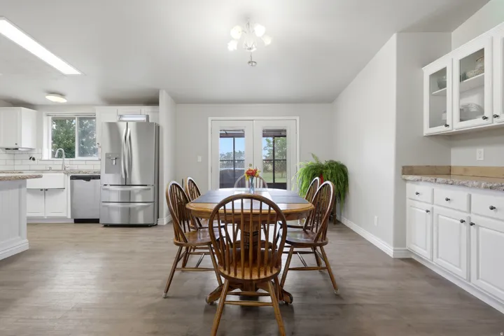 Open concept living area with wood-finish flooring