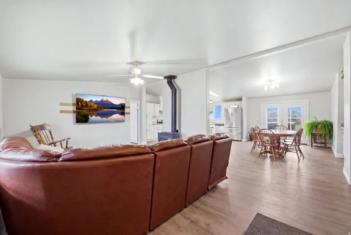 Wood-finish flooring throughout, with a ceiling fan in the living area