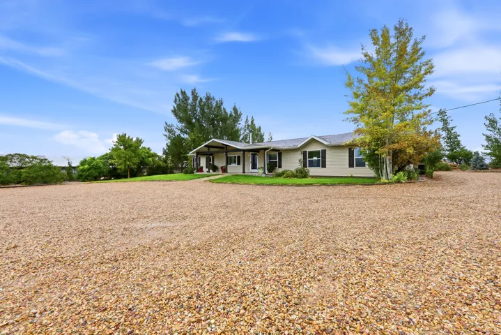 Expansive gravel driveway providing ample parking