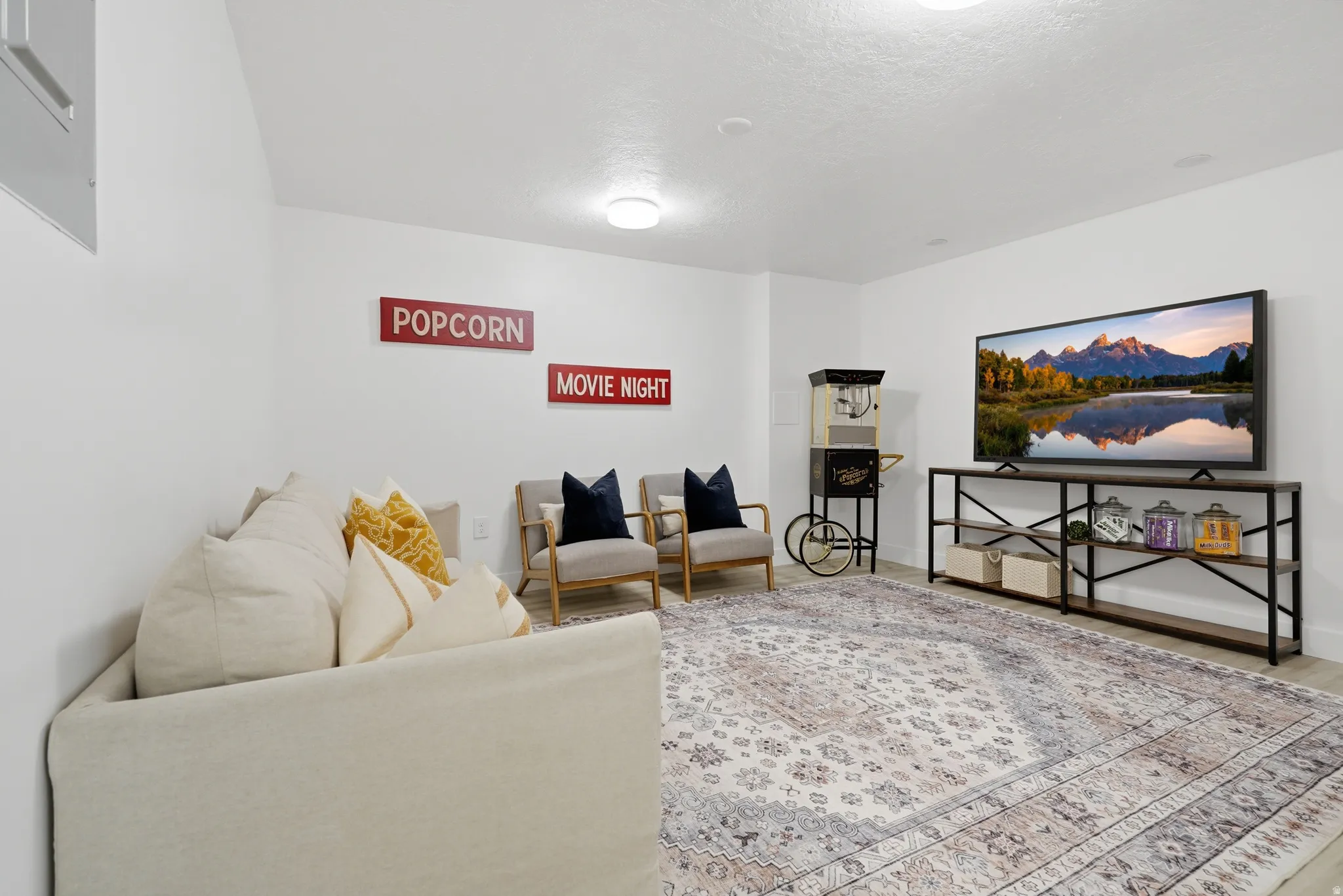 ADU spacious flex room with light-colored laminate flooring, recessed lighting, and a neutral color palette