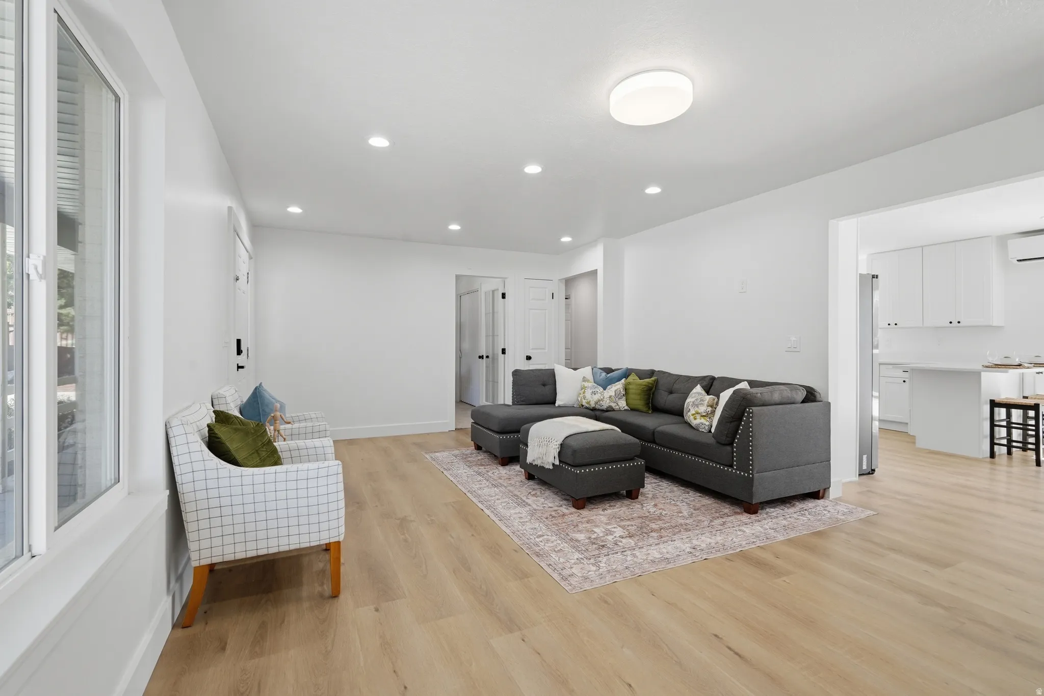 Bright interior with wood-finish flooring, and recessed lighting