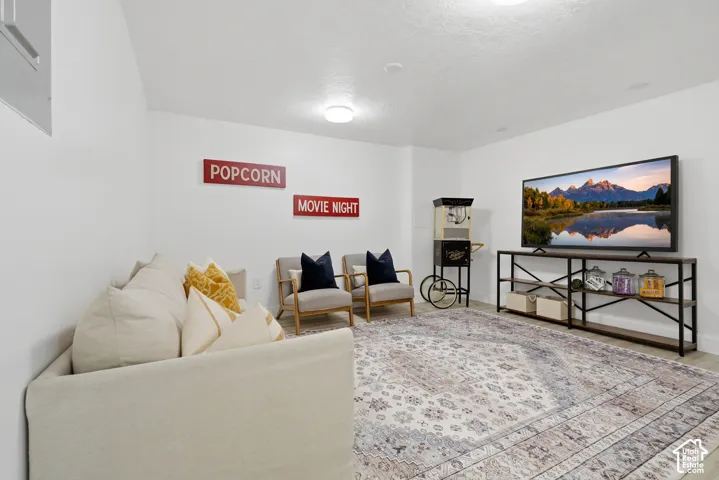 ADU spacious flex room with light-colored laminate flooring, recessed lighting, and a neutral color palette