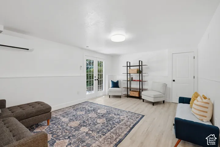 ADU living room with light laminate flooring, exterior entrance.