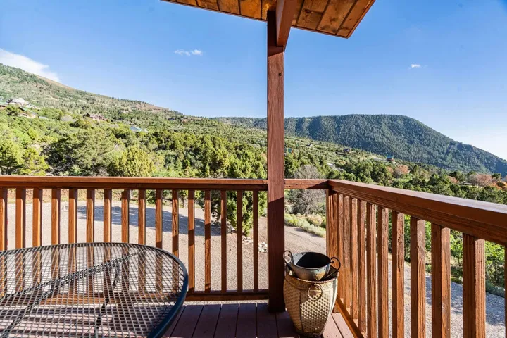 Wood-plank outdoor decking with a wood railing and support beams