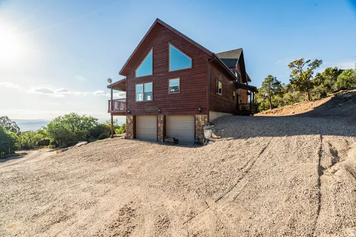 Wood-sided exterior featuring A-frame windows and a stone foundation