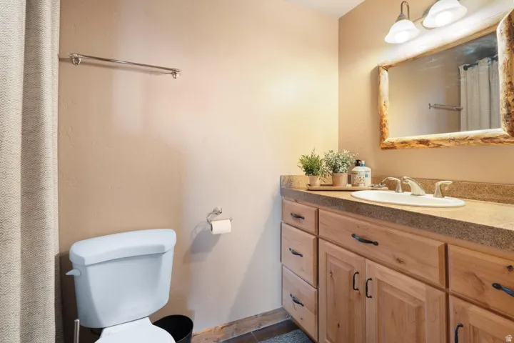 Wood-finish vanity with an integrated sink and a textured countertop