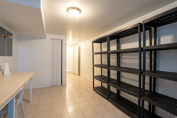 Ceramic tile flooring, built-in storage shelving, interior lighting, and a neutral color palette