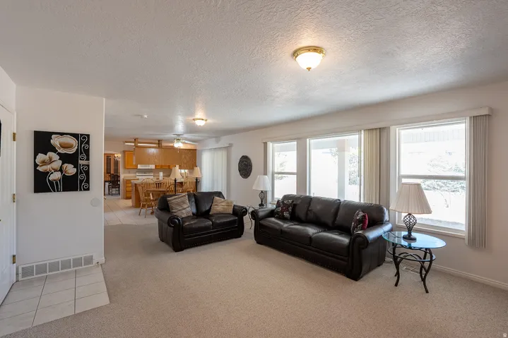 Recessed lighting and ceiling-mounted fixture illuminate the room