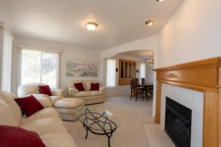 Living area with a fireplace featuring a wood surround and tile hearth