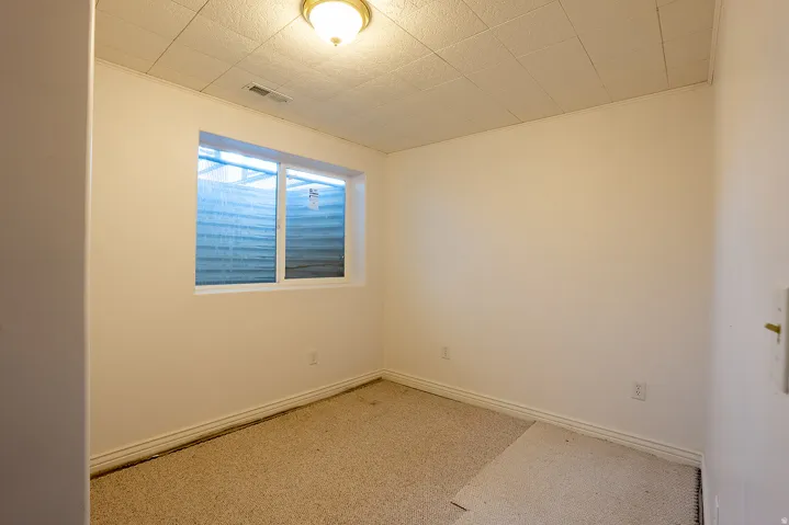 Recessed window with white trim, wall-to-wall carpeting, and a flush mount ceiling light