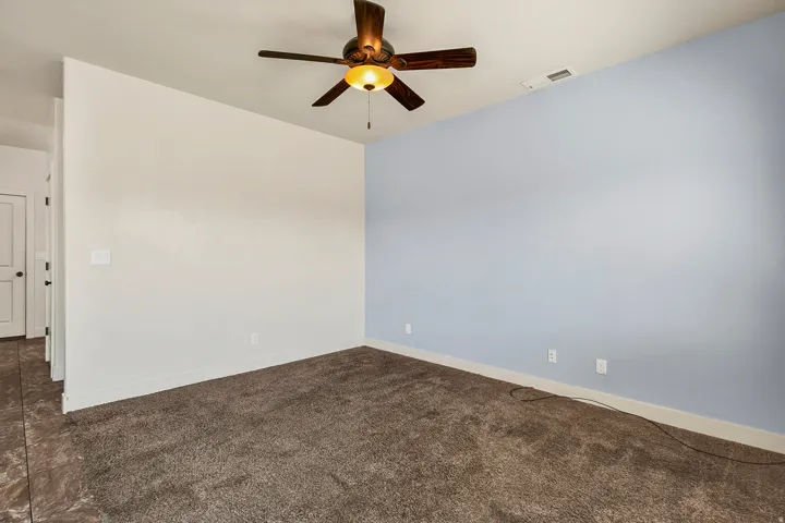 Warm-toned carpeting and light blue wall