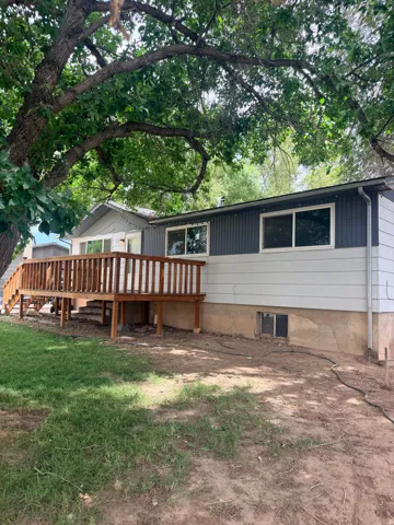 Expansive wooden deck with railing, providing outdoor living space