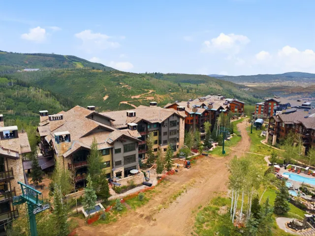 Multi-story residential buildings with wood shingle roofs and stone accents
