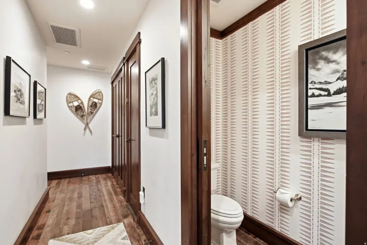 Hardwood flooring, recessed lighting, and rich wood trim