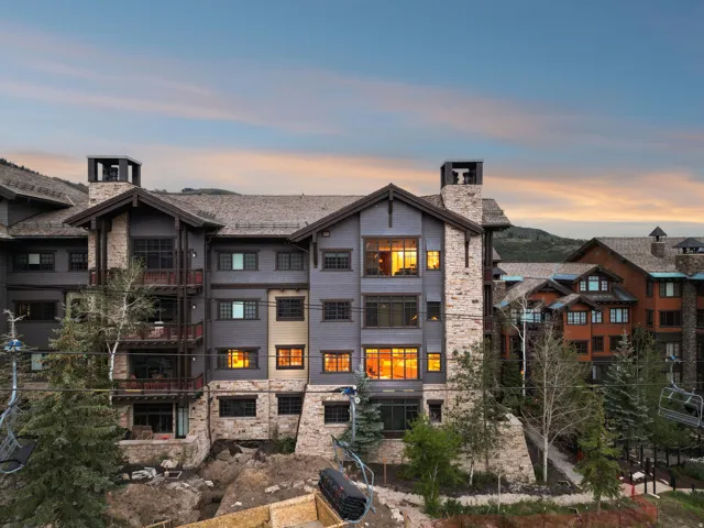 Multi-story building featuring stone and siding exterior construction