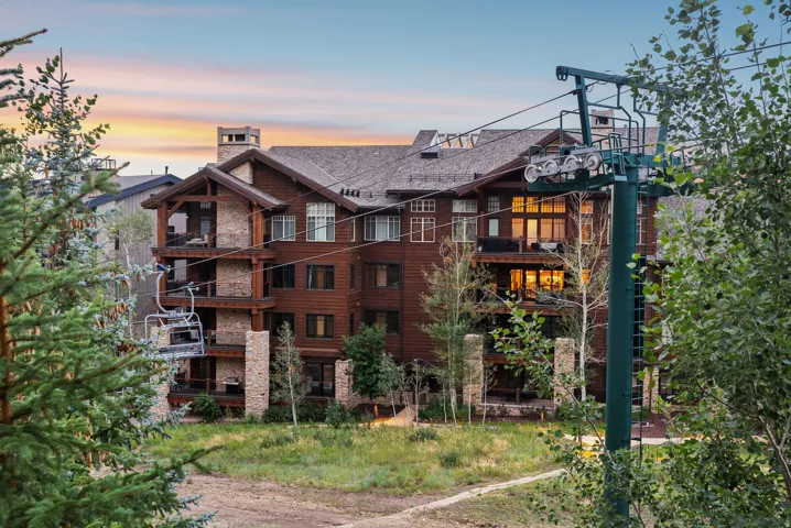 Multi-story building featuring wood siding and stone accents