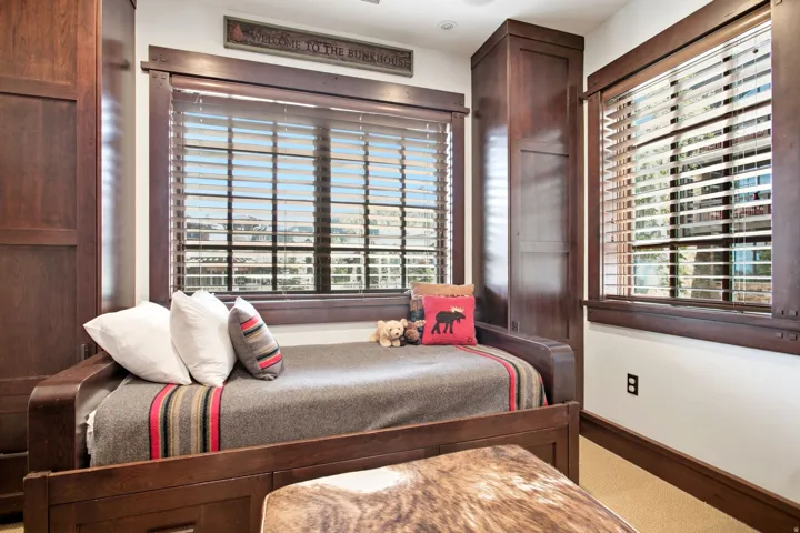 Built-in cabinetry, wood-finish window blinds, and recessed lighting