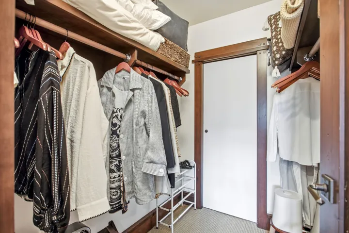 Built-in closet system featuring natural wood shelving and hanging rods