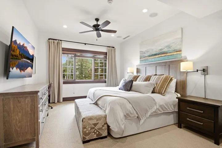 Light-colored carpeted flooring, white walls, wood-framed multi-pane windows, ceiling fan, and recessed lighting