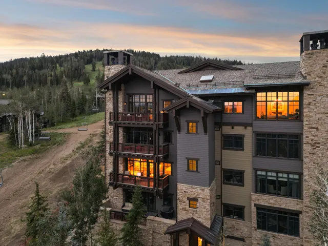 Stone and wood-sided exterior with multiple private balconies