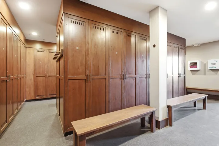 Wood-finish locker storage with built-in ventilation and a uniform design