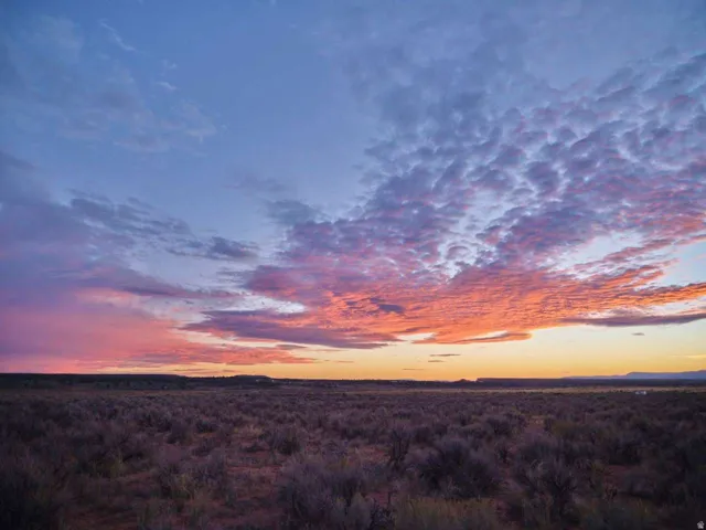 Expansive natural landscape with a vibrant sunset sky