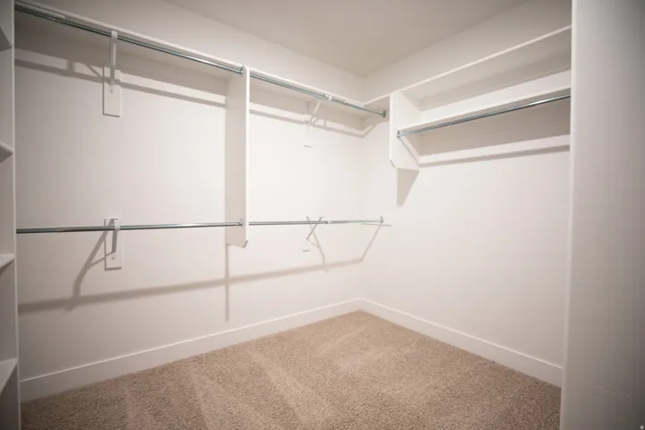 Primary bedroom walk-in closet