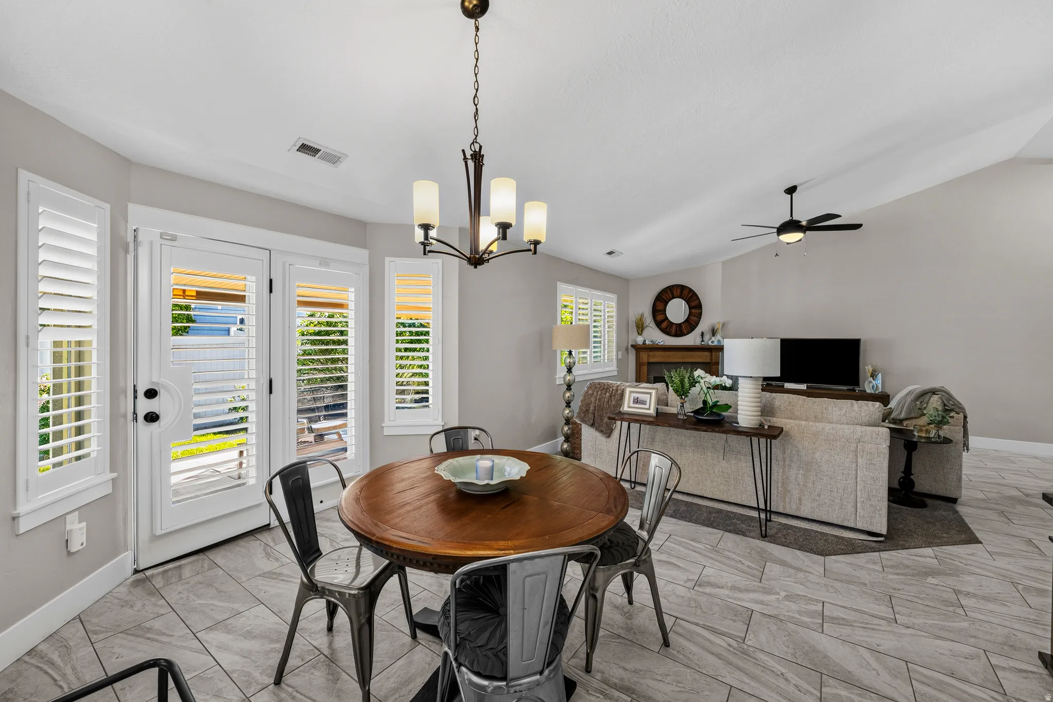 Dining area featuring a wood-top table and an overhead chandelier