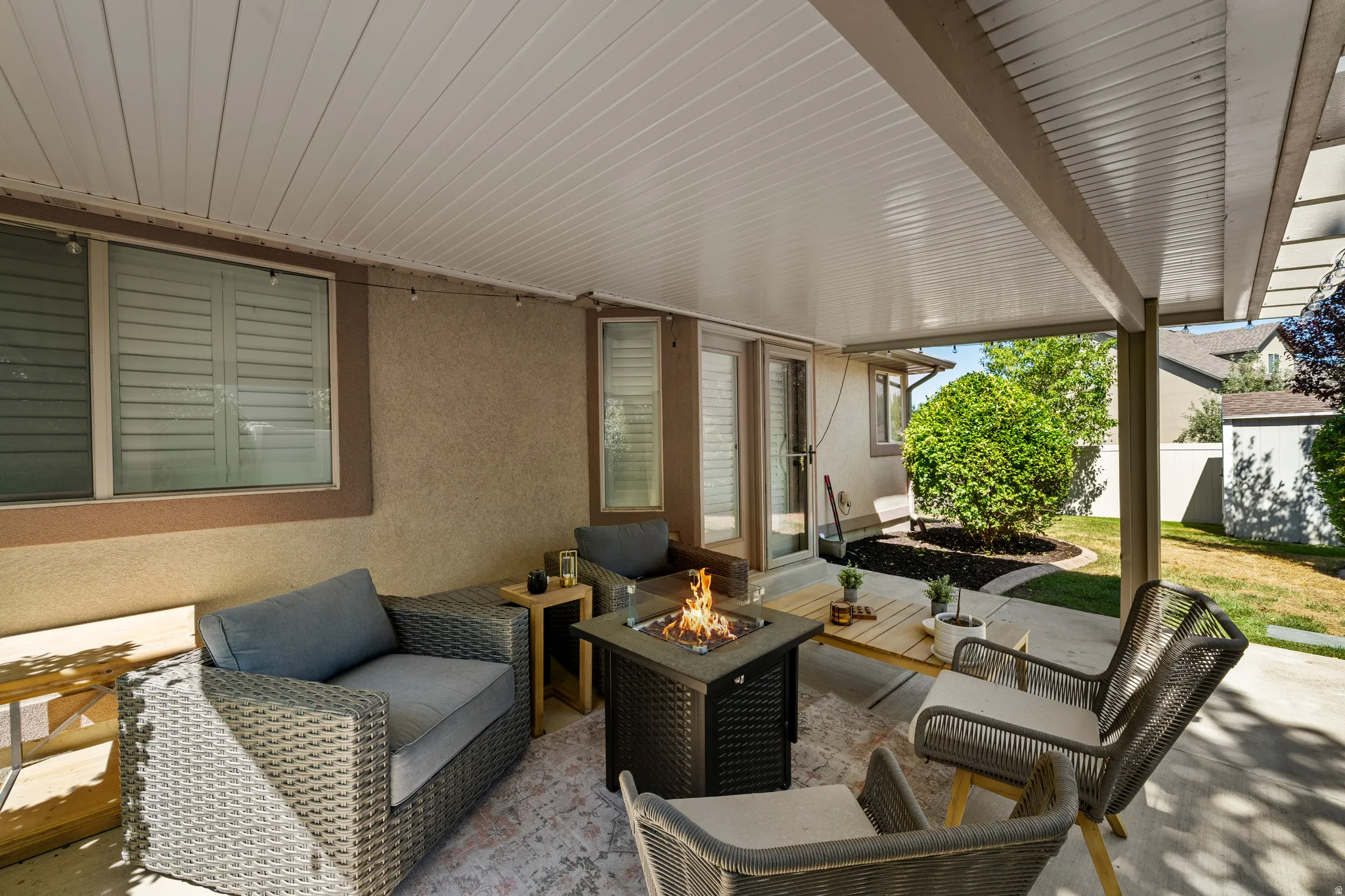 Covered patio with a fire pit feature, direct exterior access, and a concrete patio surface