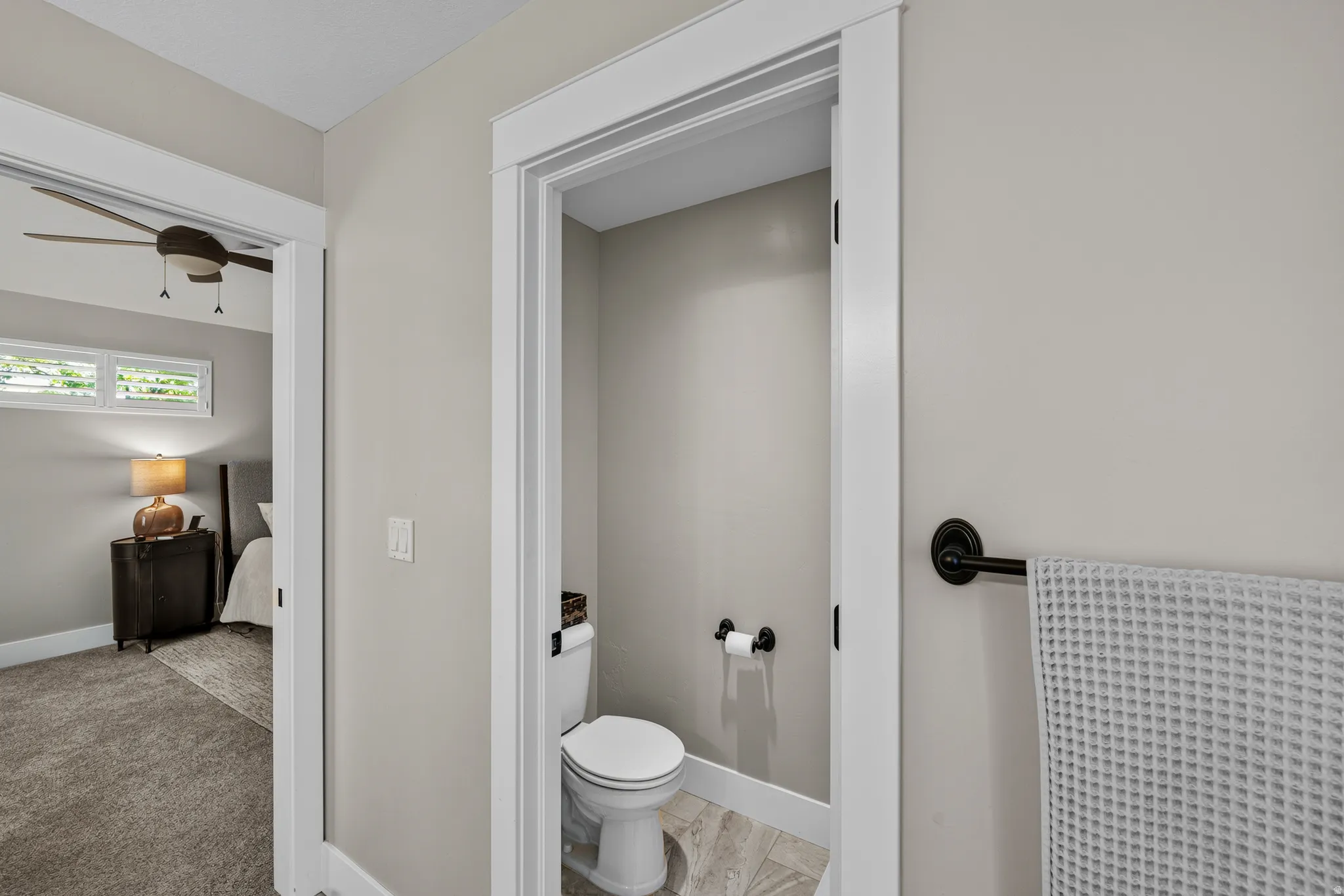 Powder room featuring a white toilet and tile flooring