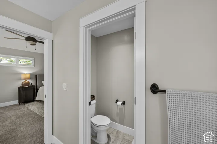 Powder room featuring a white toilet and tile flooring