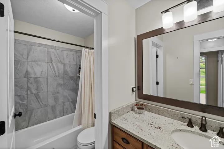 Vanity with a light-toned countertop, undermount sink, and dark-toned faucet