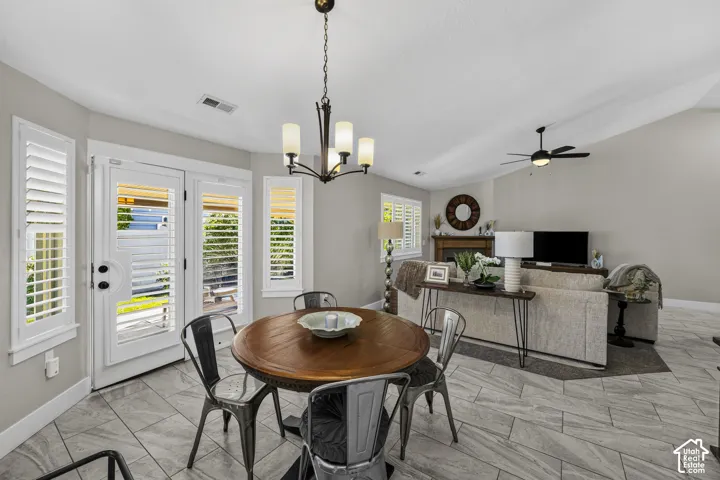 Dining area featuring a wood-top table and an overhead chandelier