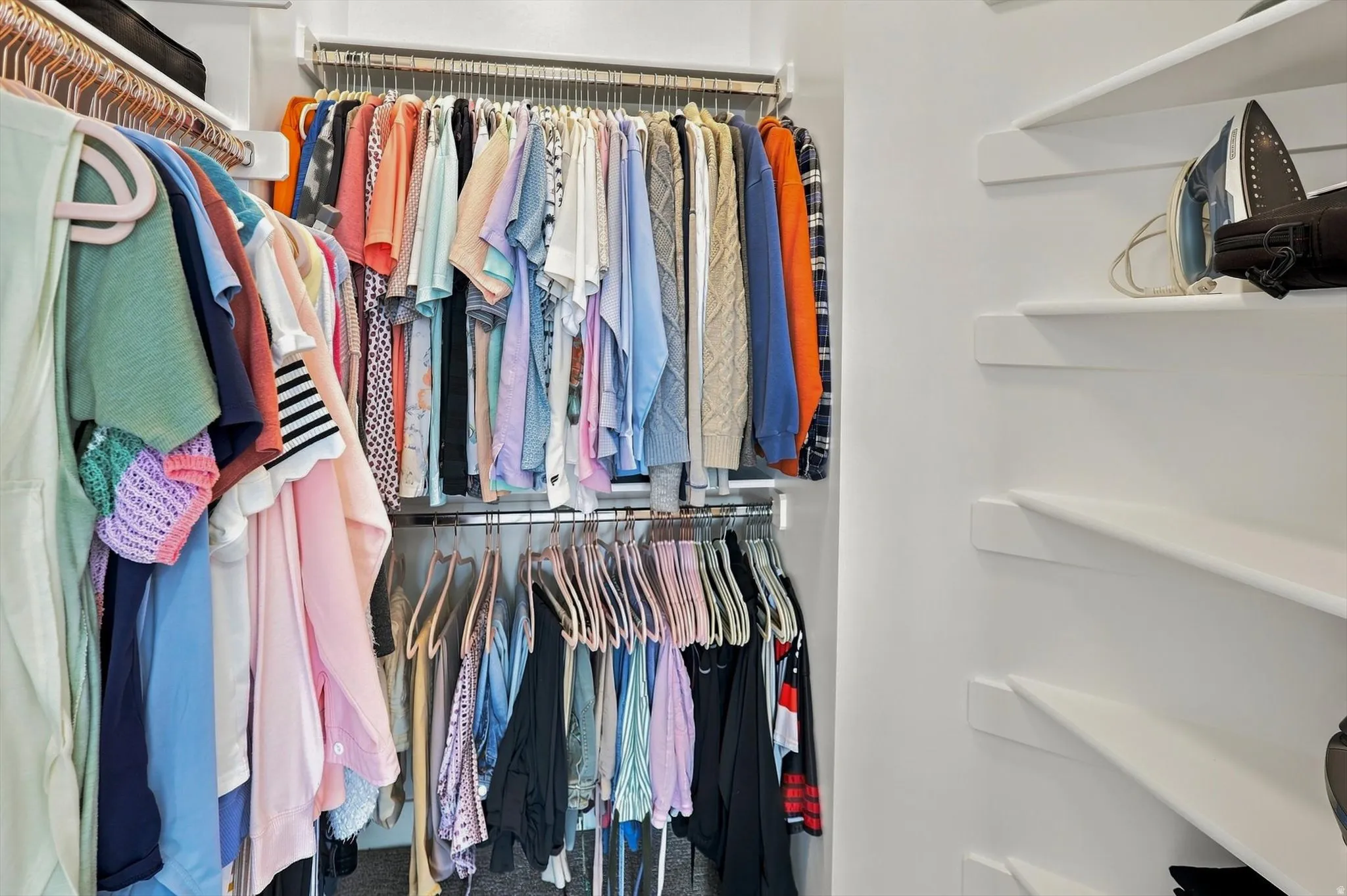 White shelving system with multiple hanging rods