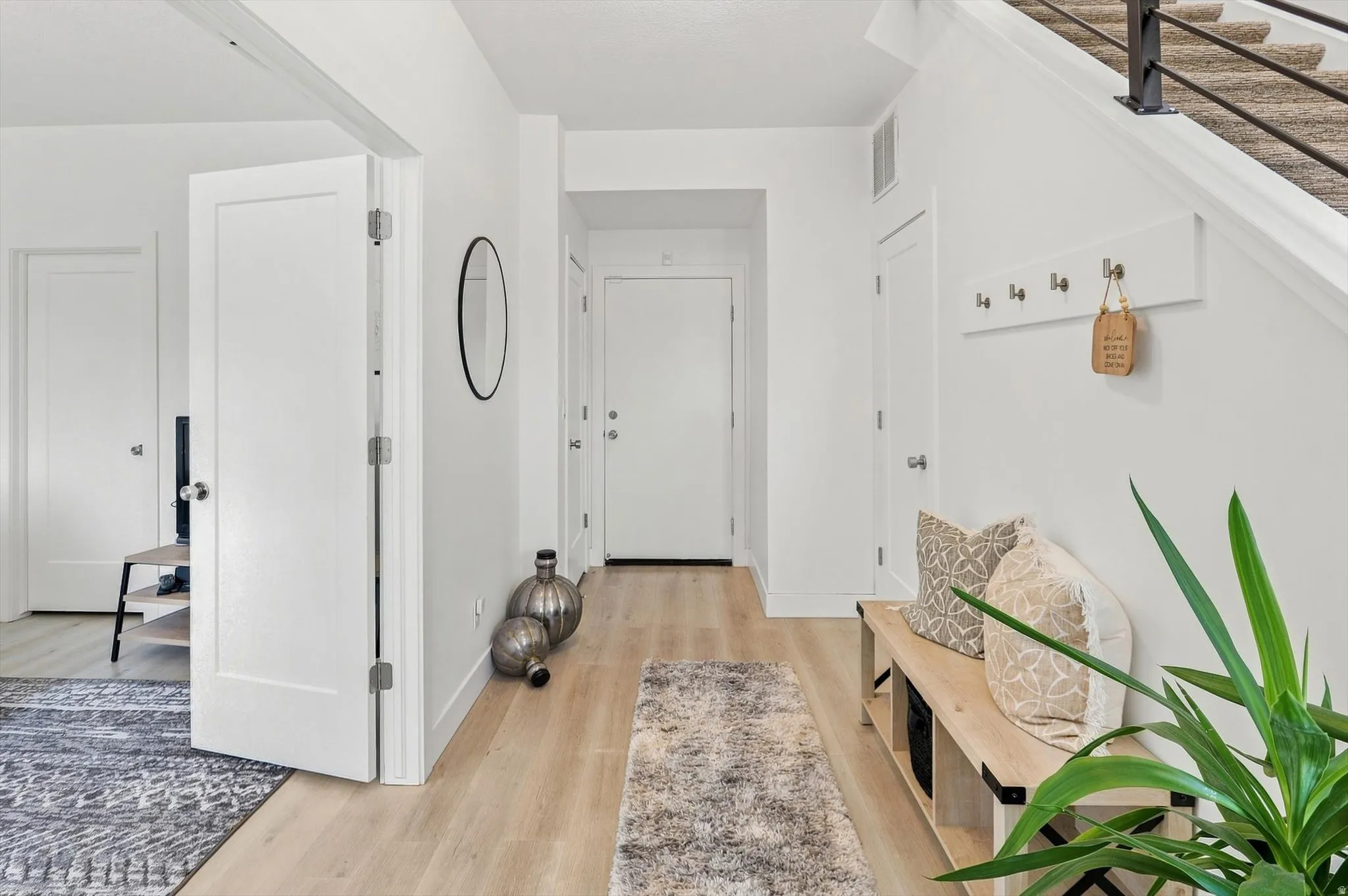 Light wood-finish flooring extending from the entryway