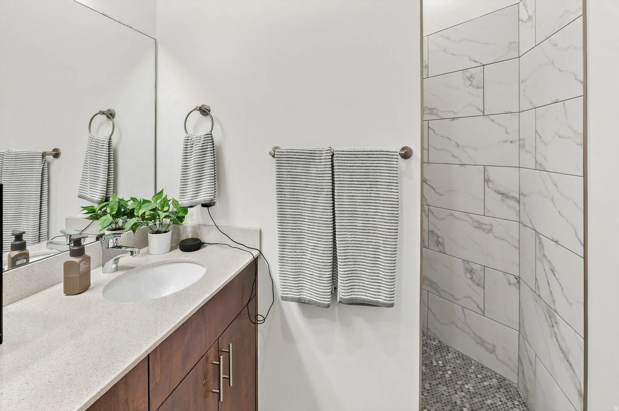 Integrated vanity with a white oval sink and light-toned countertop