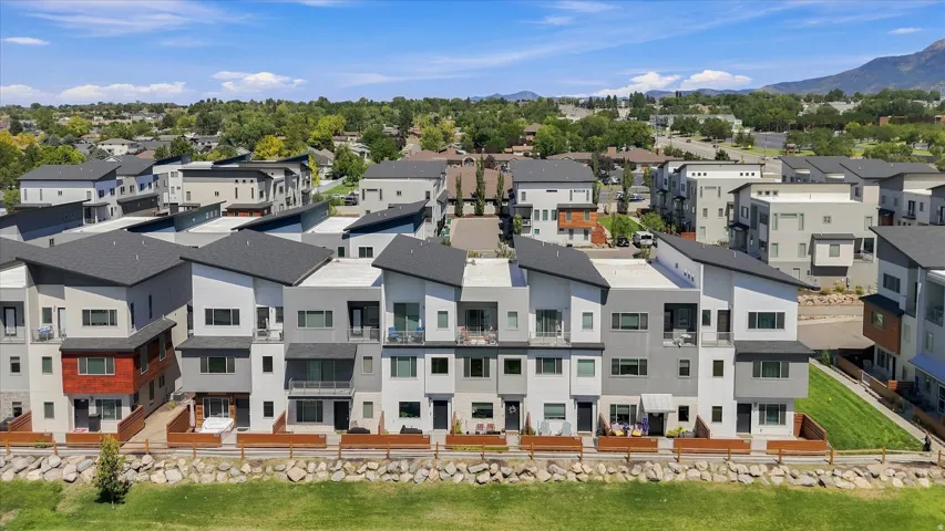 Modern townhomes featuring multi-tone facades, private balconies, and adjacent green spaces