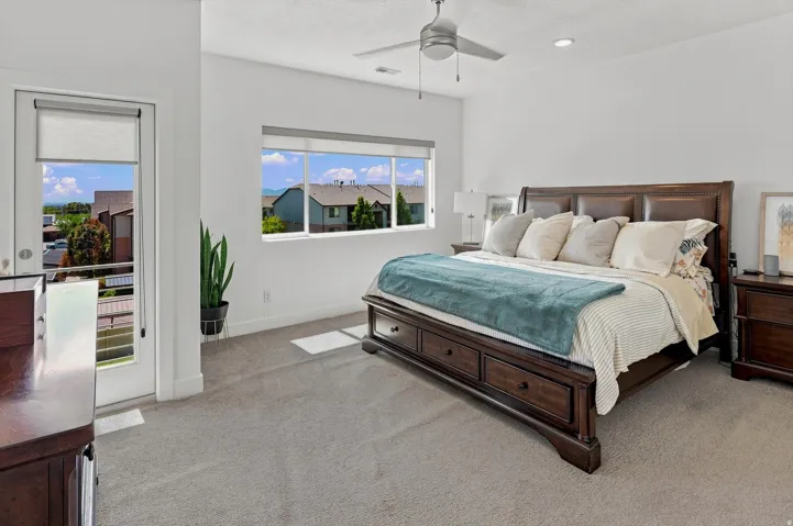 White walls with a ceiling fan, recessed lighting, and a large window