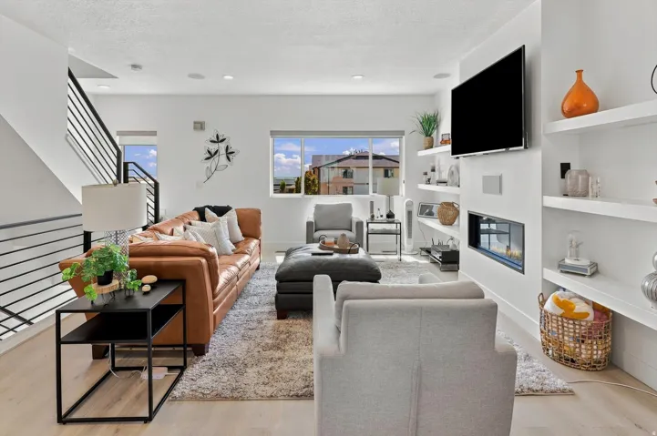 Open-concept living space with light wood-finish flooring