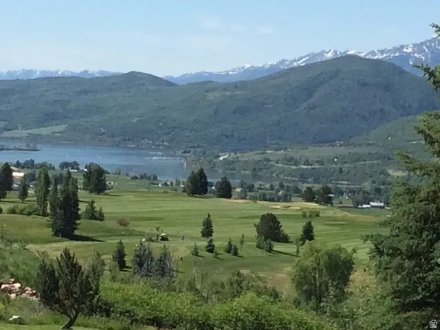 Expansive golf course setting featuring manicured greens and mature trees