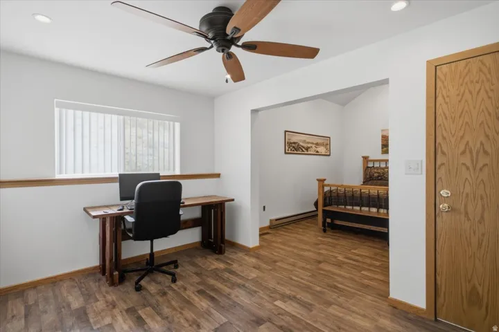Wood-finish flooring, recessed lighting, and a ceiling fan