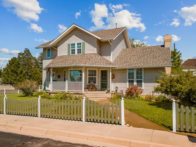 Two-story residence with light-toned siding and a shingled roof