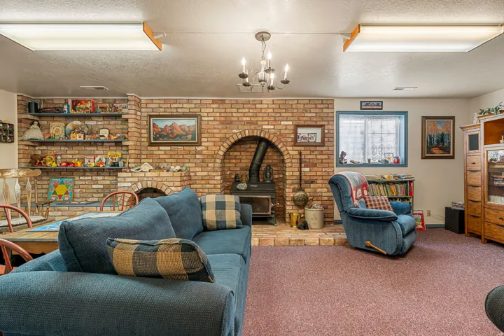 Brick feature wall with arched fireplace, integrated shelving, and recessed window