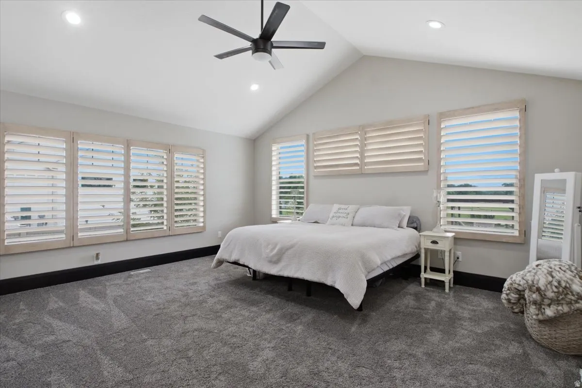 Vaulted ceiling with recessed lighting and a ceiling fan